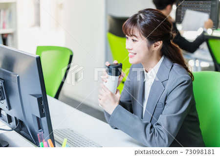 A businessman who works with a personal computer in the office A businessman who works with a personal computer in the office 73098181