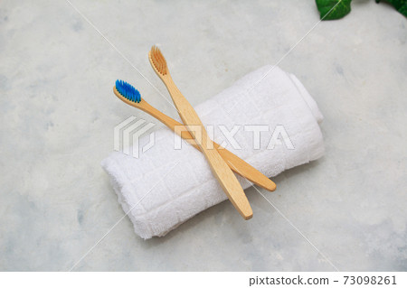 Eco bamboo tooth brushes on white towe in white background Eco bamboo tooth brushes on white towe in white background 73098261