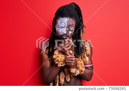 funny primitive african native guy trying to use modern cutlery 73098265