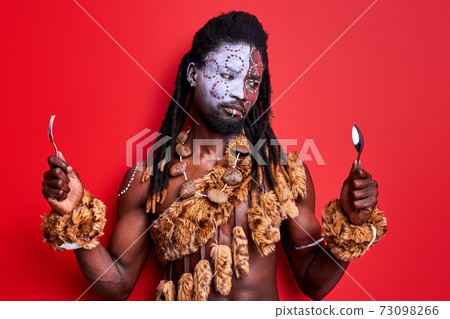 african aborigen male holding spoon and fork in hands, choosing african aborigen male holding spoon and fork in hands, choosing 73098266