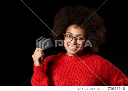 Discontent serious young African-American girl in glasses and red shirt 73098648