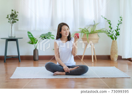 Beautiful asian woman staying fit by exercising at home for healthy trend lifestyle Beautiful asian woman staying fit by exercising at home for healthy trend lifestyle 73099395