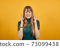 Crosses fingers, prays before important occasion, wishes luck, hopes in victory 73099438
