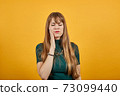 Touching mouth with hand painful expression toothache struggling dental 73099440