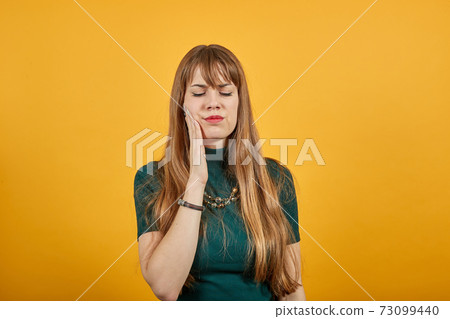 Touching mouth with hand painful expression toothache struggling dental Touching mouth with hand painful expression toothache struggling dental 73099440