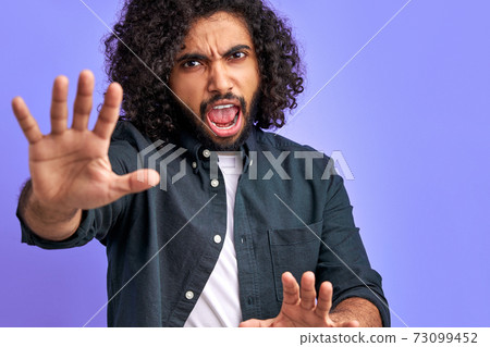 curly male got everything under control, raising hand up in calm down, wait sec or stop gesture curly male got everything under control, raising hand up in calm down, wait sec or stop gesture 73099452