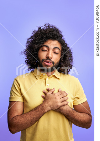 grateful arabic male holding hands on chest grateful arabic male holding hands on chest 73099456