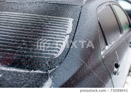 part of a car covered with ice at shallow depth of field part of a car covered with ice at shallow depth of field 73099641
