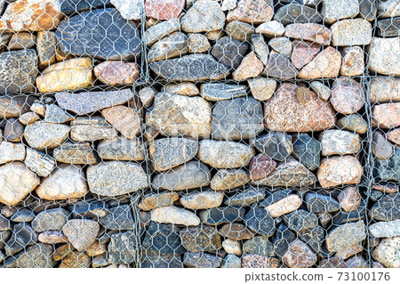 Stone wall with metal grid as background Stone wall with metal grid as background 73100176