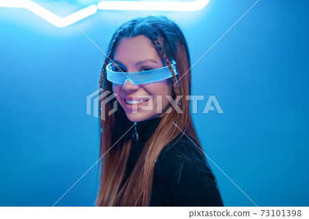 Young woman smiling in futuristic glasses. New noir Young woman smiling in futuristic glasses. New noir 73101398