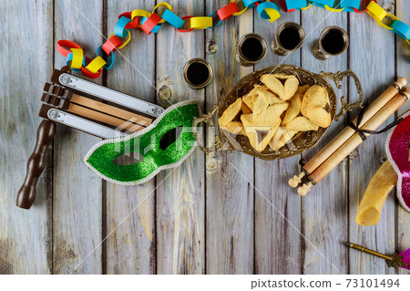 Carnival with noisemaker Hamantaschen cookies Purim jewish holiday Carnival with noisemaker Hamantaschen cookies Purim jewish holiday 73101494