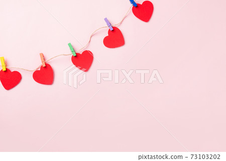 red heart shaped valentines decoration hanging with paper clips red heart shaped valentines decoration hanging with paper clips 73103202