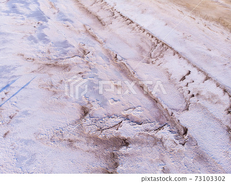 Amazing forms of land surface made of water and salt, nature abstract background, aerial view. Pink extremely salty Kuyalnik Liman in Odessa, Salty layer on the bottom of Shallow Lake 73103302