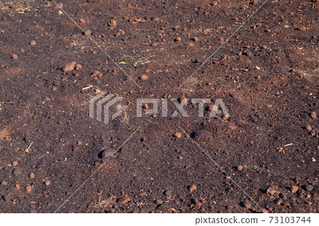 Plowed soil on a sunny day 73103744