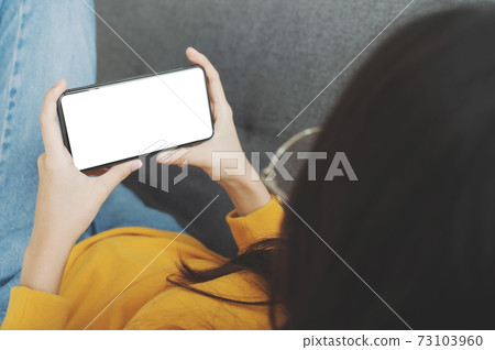 Woman using mobile smartphone and device white screen empty space smart phone Woman using mobile smartphone and device white screen empty space smart phone 73103960