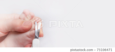 Banner.Baby manicure. Mother cutting kids nails. 73106471