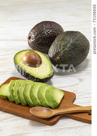 Avocado cut and placed on a white plate and a mini plate Avocado cut and placed on a white plate and a mini plate 73106688
