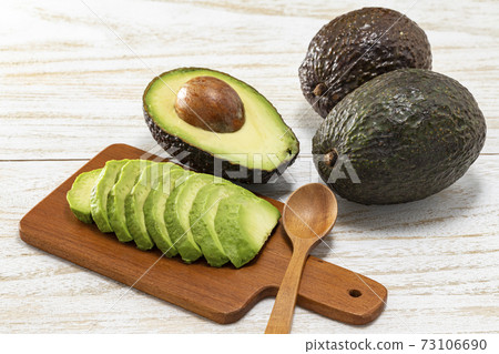 Avocado cut and placed on a white plate and a mini plate Avocado cut and placed on a white plate and a mini plate 73106690