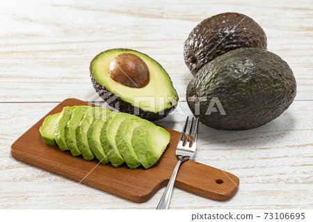 Avocado cut and placed on a white plate and a mini plate Avocado cut and placed on a white plate and a mini plate 73106695