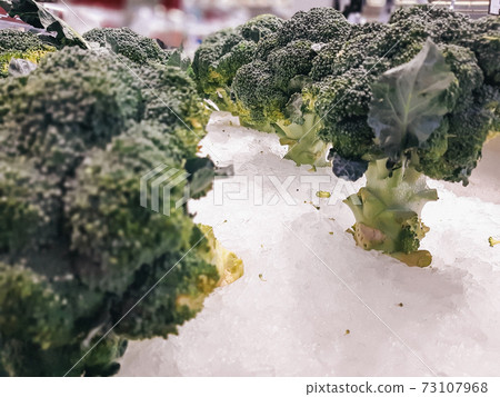 Fresh Broccoli in a pile at supermarket, Healthy Fresh Green raw Broccoli. background, texture. 73107968