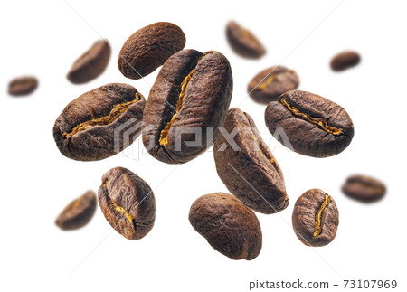 Coffee beans levitate on a white background Coffee beans levitate on a white background 73107969