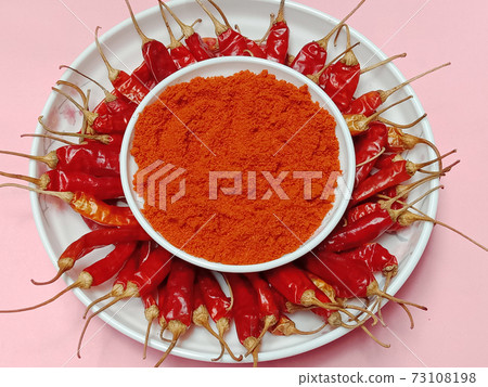 red hot spicy chili peppers on plate 73108198