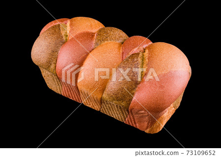Freshly baked homemade bread isolated on black. Colorful bread made of vegetables. Australian braided bread made with vegetable puree. Healthy eating and traditional bakery, baking bread concept 73109652