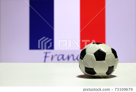 Small football on the white floor and out focus Tri Color or blue white and red color  73109679