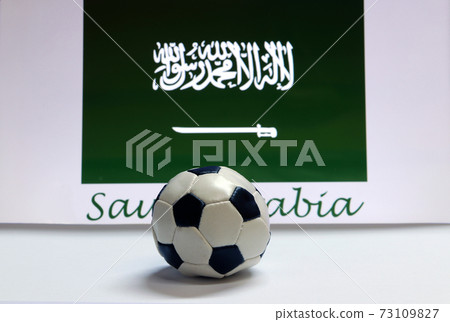 Small football on the white floor and Saudi Arabian nation flag with the text of Saudi Arabia Small football on the white floor and Saudi Arabian nation flag with the text of Saudi Arabia 73109827