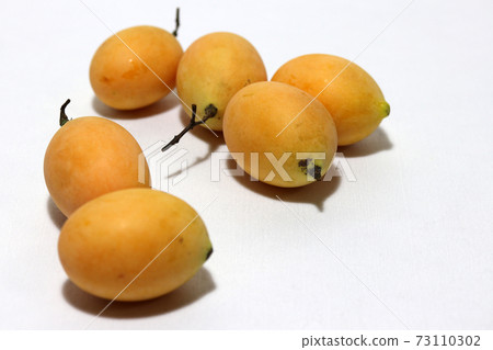 Bouea macrophylla, commonly known as gandaria put stack on white background. Bouea macrophylla, commonly known as gandaria put stack on white background. 73110302