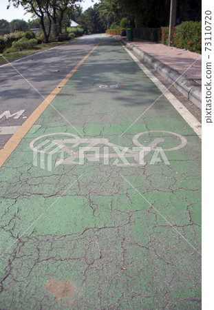The white bicycle painting on the green bike lane. The white bicycle painting on the green bike lane. 73110720