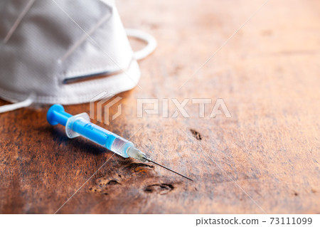 Injection syringe. Covid-19 coronavirus vaccination. Corona virus vaccine. 73111099