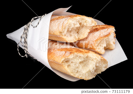 Freshly baked homemade bread isolated on black. French bread baguette. Healthy eating and traditional bakery, baking bread concept 73111179