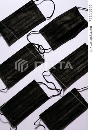 Surgical black mask with rubber ear straps. Procedure mask from bacteria. Protection concept. 73111965