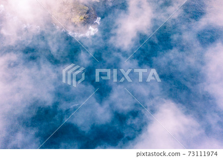 Dramatic aerial view of clouds from above at the Slieve League cliffs in County Donegal, Ireland 73111974