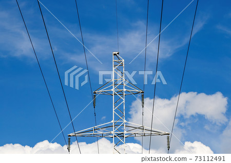 High voltage transmission lines against the blue sky. 73112491
