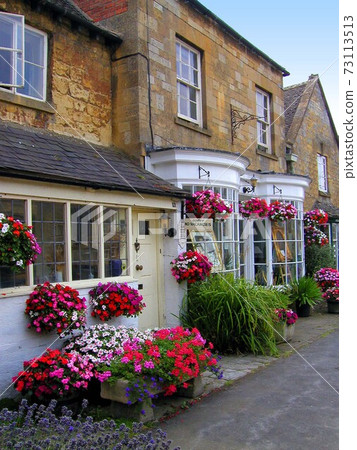 Colorful flowers at the Cotswolds storefront that leave a honey-colored cityscape 73113513