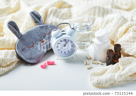 Sleeping mask, alarm clock, earplugs and pills. Healthy night sleep creative concept. 73115144