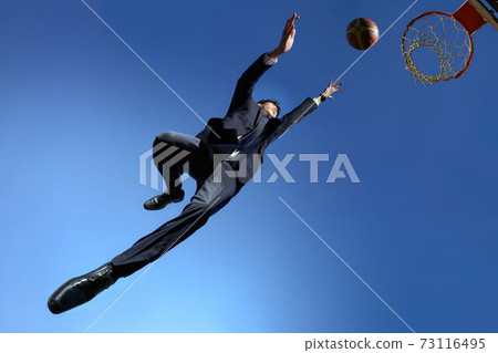 Basketball man in a suit shooting business image Basketball man in a suit shooting business image 73116495