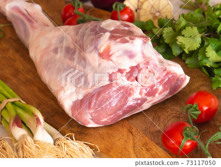 Fresh and raw meat. Leg of lamb on wood background Fresh and raw meat. Leg of lamb on wood background 73117050