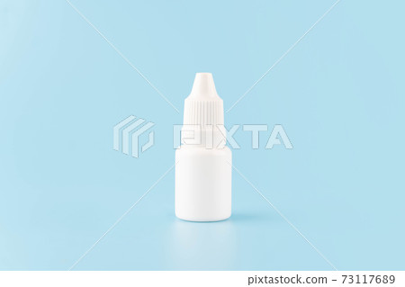 Eye drop or ear drop bottle on light blue background. Blank white plastic container for fluid. Pharmaceutical packaging product. Eye drop or ear drop bottle on light blue background. Blank white plastic container for fluid. Pharmaceutical packaging product. 73117689
