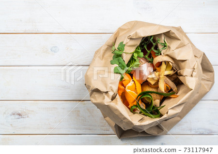 Composting concept - kitchen leftovers in paper bag Composting concept - kitchen leftovers in paper bag 73117947