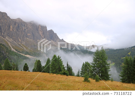Foggy mountain landscape in Dolomites in Italy. 73118722
