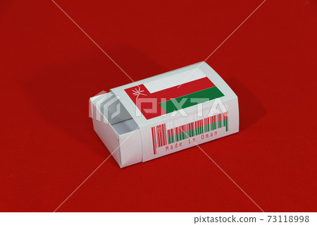 Oman flag on white box with barcode and the color of nation flag on red background 73118998