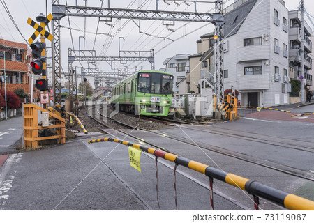 Keio Line bound for Mt. Takao Green vehicle railroad crossing 73119087