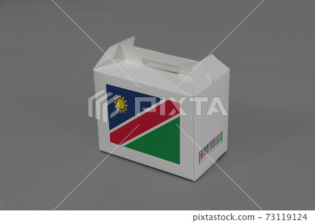 Namibia flag on white box with barcode and the color of nation flag on grey background. Namibia flag on white box with barcode and the color of nation flag on grey background. 73119124