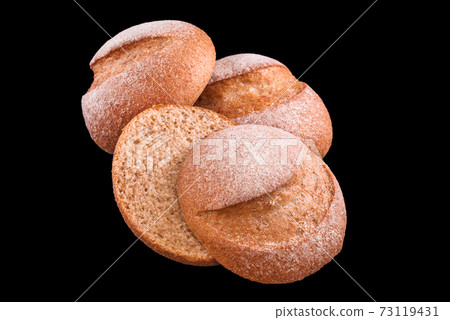 Freshly baked homemade bread isolated on black. Fresh white bread buns. Healthy eating and traditional bakery, baking bread concept Freshly baked homemade bread isolated on black. Fresh white bread buns. Healthy eating and traditional bakery, baking bread concept 73119431