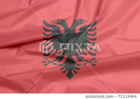 Fabric flag of Albania. Crease of Albanian flag background 73119464