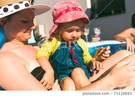 Summer sun with child concept. Baby with mother in summer sun 73119683