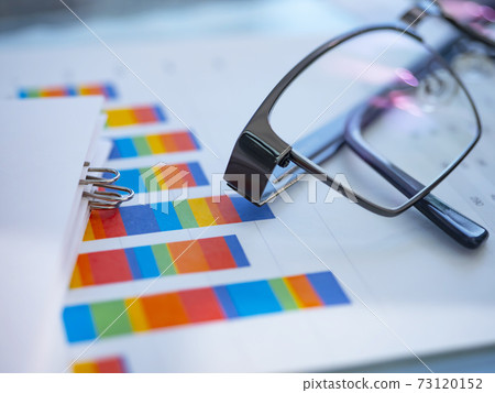 Business image, graph, glasses, documents Business image, graph, glasses, documents 73120152